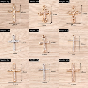Nine assorted gold and silver alloy cross pendants with rhinestones for DIY jewelry making