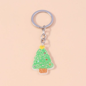 Détail d'un porte-clés sapin de Noël graffiti vert avec anneau métallique argenté