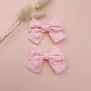 Set of two pink linen bow hair clips for girls with a minimalist handmade design