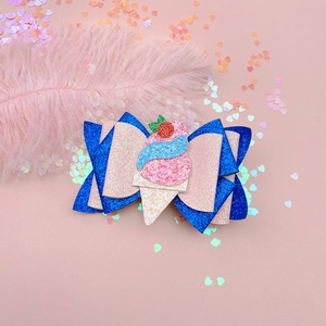 Macro shot of glitter ice cream bow hair clip with blue and pink sequins on pink feather