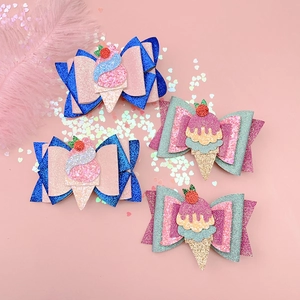 Detailed macro view of four glitter ice cream hair clips for girls on pink background