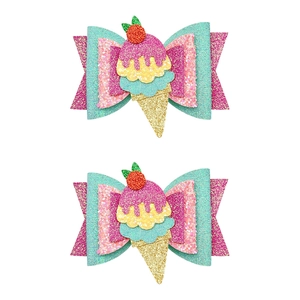 Close-up of glitter bow hair clips with sweet ice cream center and colorful sequins