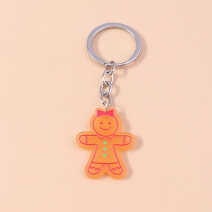 Détail d'un porte-clés bonhomme en pain d'épices orange avec un nœud rouge