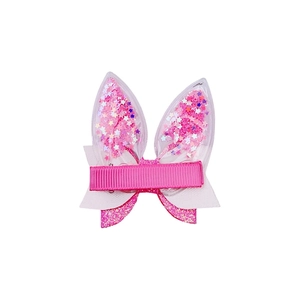Detail of Easter bunny ear hair clip with pink sequins and glitter bow decoration
