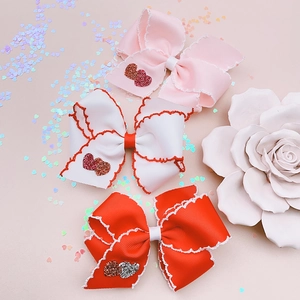 Set di tre fermagli per capelli con fiocchi e cuori glitterati per bambine