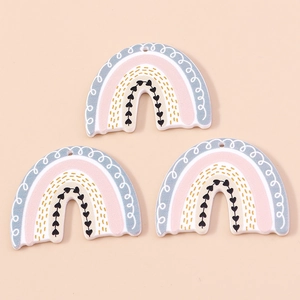 Macro view of pastel acrylic rainbow charms with heart detail for DIY jewelry making