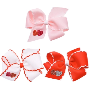 Set di tre fermagli per capelli a fiocco con cuore in rosa bianco e rosso