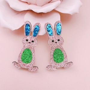 Detailed close-up of pink glitter Easter bunny hair clips with sequins and floral decor