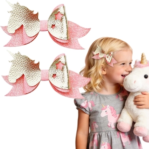 Pink glitter unicorn bow hair clips for girls featuring shiny star cutouts and faux leather