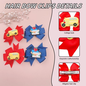 Detailed view of hair bow clips with school bus pendants and sturdy alligator clips