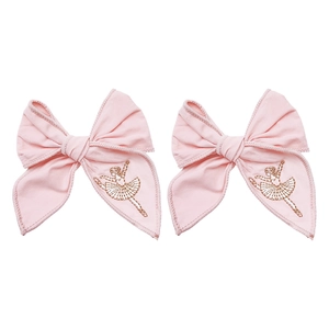 Detail of pink cotton hair clips set featuring delicate gold ballet dancer embroidery