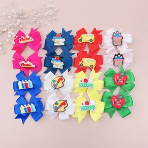 Detailed set of eight colorful school-themed hair bows with creative pencil and bus charms