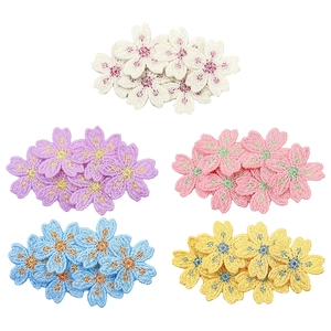 Detailed close-up of embroidered floral hair clips in five pastel colors with fine textures