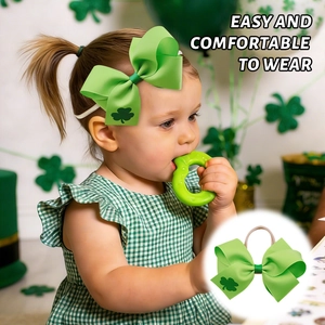 Close-up of green shamrock bow nylon headband worn by a toddler for St. Patrick's Day