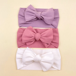 Three-pack of elastic ribbed baby headbands with large bows in purple, pink, and white colors
