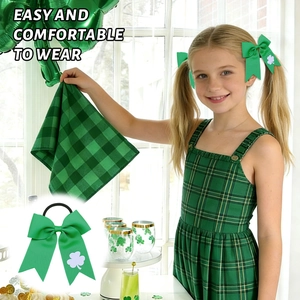Detail of St. Patrick's Day green grosgrain ribbon bow with clover print on kids' pigtails
