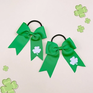 Detail view of St. Patrick's Day green hair bows with white shamrock pattern