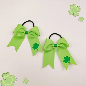 Detailed view of St. Patrick's Day green clover print grosgrain ribbon hair bows