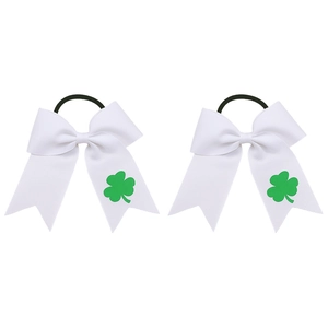 Detail of white grosgrain hair bows with green shamrock prints and black elastic bands