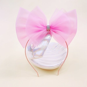 Serre-tête rose avec nœud en tulle pour filles et centre scintillant sur un cercle fin