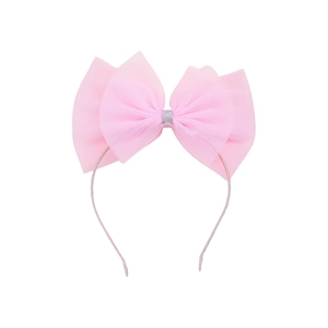 Détail d'un serre-tête rose avec grand nœud en tulle et centre pailleté argenté pour filles