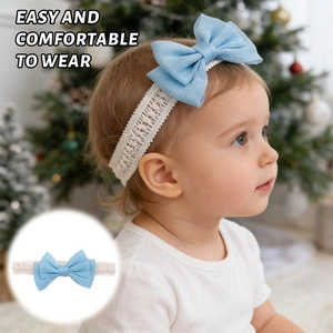 Detail of baby elastic lace headband with light blue bow tie and festive holiday theme