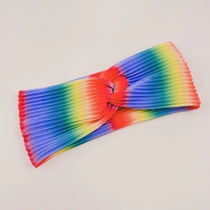 Detailed view of rainbow gradient fabric texture and twisted knot design on the headband