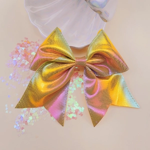 Macro detail of holographic laser bow hair clip with shimmering metallic grid texture