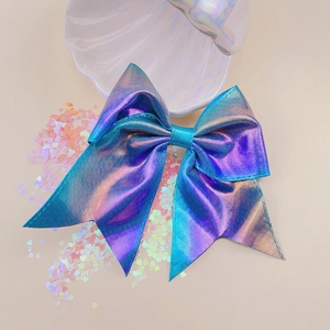 Detail of laser holographic bow hair clip with gradient purple fabric texture