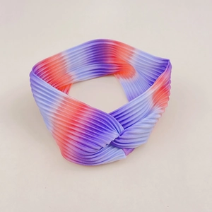 Detail of twisted rainbow gradient yoga headband with vertical pleated elastic fabric