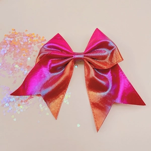 Close-up of laser leather bow hair clip with colorful gradient and square texture pattern