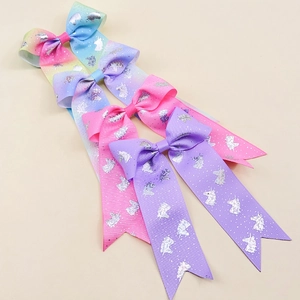 Detail of macaron gradient ribbon bows with silver glitter unicorn patterns for girls