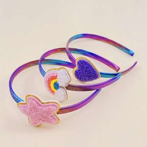 Detailed view of iridescent fabric headbands with sequined star, cloud, and heart patches