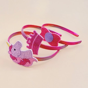 Three-piece girls' headband set with glittery unicorn, crown, and red bow decorations