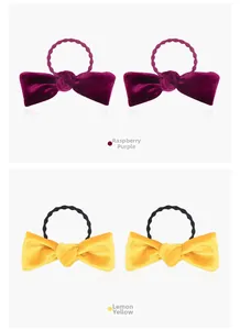 Close-up of soft velvet bow hair ties in raspberry purple and bright lemon yellow colors