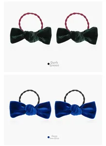 Detail view of velvet bow hair ties in dark green and deep sea blue colors