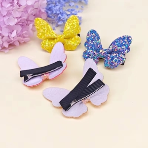 Sparkly glitter butterfly hair clips for girls in blue and yellow with fabric wrapped clips