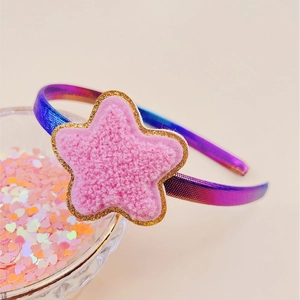 Close-up of girls blue purple metallic headband with pink plush star and gold glitter edge