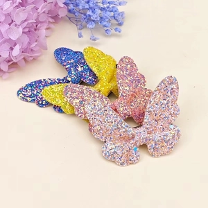 Detail view of colorful glitter butterfly hair clips with sparkling sequins for girls