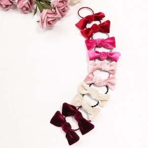 Velvet bow hair scrunchies set in various pink and red tones for girls and women