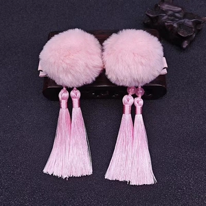 Detail of pink faux fur pom pom hair clips with long tassels and beads for Hanfu outfits