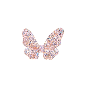 Macro shot of butterfly hair clip with pink, blue, and gold glitter sequins finish