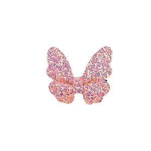 Close-up of glittery butterfly hair clip with pink and purple sequins and center waist detail
