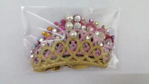 Detailed view of children crown headbands with glitter, faux pearls and colorful rhinestones