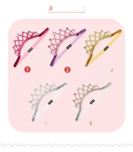 Detail view of five glittery baby crown headbands with pearls and colorful rhinestones