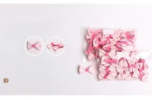 Detail of baby bow hair clips in pink polka dot and striped patterns with 20 pieces pack