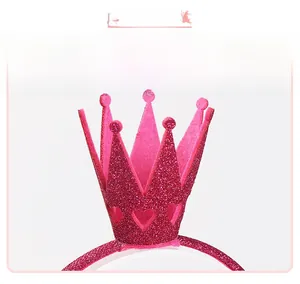 Close-up of glitter crown headband with heart cut-outs and rose red plush texture