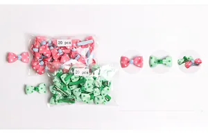 Detail of pink and green polka dot bow hair clips in 20-piece sets for baby girls