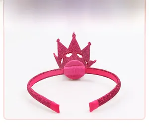 Detail showing plush rose pink glitter crown headband with soft protective ribbon ends