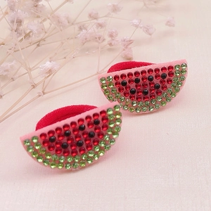 Detailed view of red watermelon hair ties with sparkling rhinestones and red elastic bands